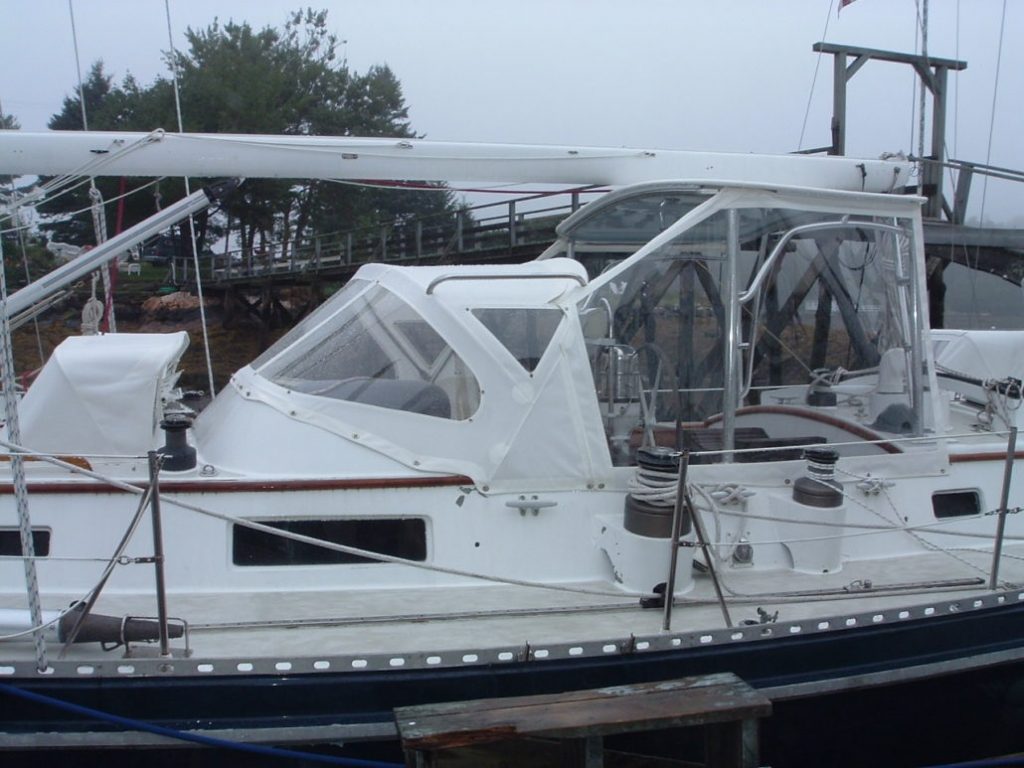 White full dodger, bimini and enclosure on sailboat