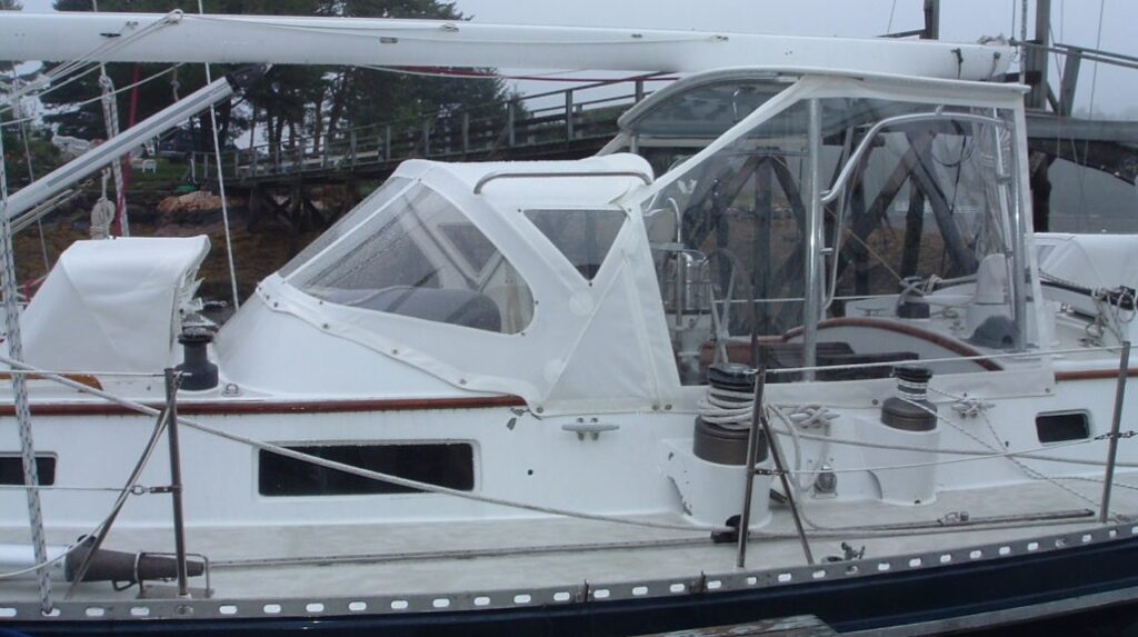 White full dodger, bimini and enclosure on sailboat